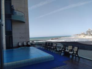 a hotel with a swimming pool and a view of the beach at דירות נופש מרינה הרצליה in Herzliyya B