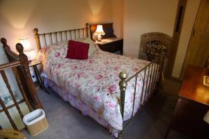 a bedroom with a bed with a red pillow on it at Cottage - Sleeps 2 - Garden - Parking in Ryton