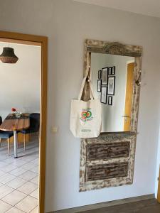 a room with a mirror and a bag on the wall at Ferienwohnung Vogesenblick in Müllheim