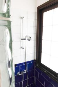 ロス・クリスティアーノスにあるEl Risco 2の青いタイルの壁のバスルーム(シャワー付)