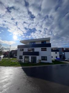 a white building with a cloudy sky in the background at Traube in Balingen