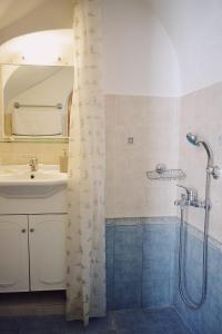 a bathroom with a sink and a shower at Yi artistry 1-bedroom medieval holiday house in Kalamoti