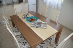 a wooden table with a plate of food on it at Apartments Brko in Maslenica