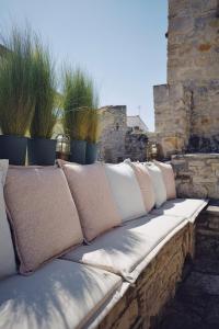 a row of pillows sitting on a stone wall at Yi artistry 1-bedroom medieval holiday house in Kalamoti