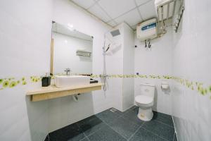 a bathroom with a sink and a toilet at My Ngoc Hotel in Cat Ba +19 photos