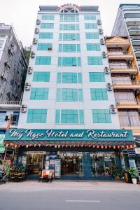 a large building with a sign for a music hotel and restaurant at My Ngoc Hotel in Cat Ba