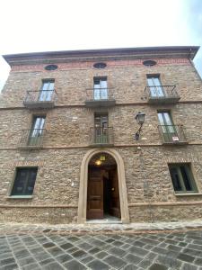 un gran edificio de ladrillo con puerta y ventanas en Domus plano de laczarulo Acciaroli, en Acciaroli