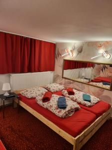 a bedroom with a large bed with red curtains at Hostel Hamburg in Hamburg
