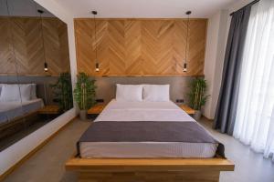 sypialnia z dużym łóżkiem i 2 doniczkami w obiekcie Leone Cunda Edition Otel w mieście Ayvalık