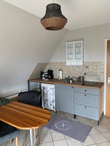 a kitchen with a counter and a sink and a table at Ferienwohnung Vogesenblick in Müllheim