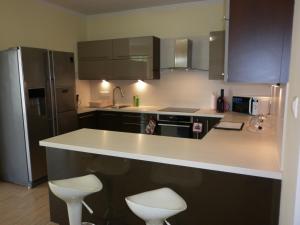 a kitchen with a white counter and a refrigerator at Luxury Villa Heviz in Hévíz