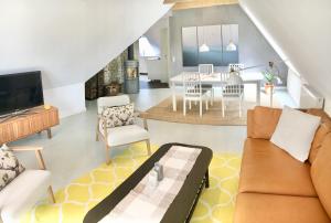 a living room with a couch and a dining room at Moorblick! Große Dachwohnung mit Kamin und Sauna in Leck