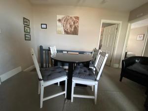 a dining room with a table and four chairs at Eclipse Apartment No 2 in Newmarket