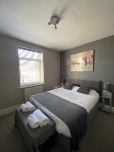 a bedroom with a large bed and a window at Eclipse Apartment No 2 in Newmarket