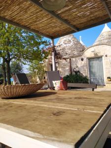 a patio with a table and chairs on it at Trulli Spinosa in Cisternino