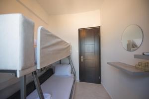 a room with two bunk beds and a mirror at Amelia Villa in Nikiana