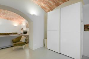 Cette chambre est dotée de murs blancs et d'un plafond en briques. dans l'établissement Exklusiv: Historisches Apartment mit Deckengewölbe, à Munich