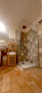a bathroom with a shower with a glass enclosure at Spartivento Apartments in Matera