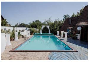 a swimming pool in the middle of a patio at Vikendica Despotovic in Bijeljina