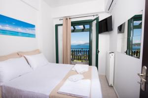 a bedroom with a bed with a view of the ocean at Amelia Villa in Nikiana