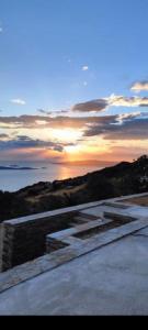 a view of the sunset from the top of a building at Aegean Deep Blue Andros Ano Aprovato in Apróvaton