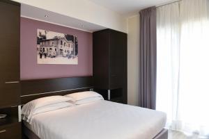 Posteľ alebo postele v izbe v ubytovaní Hotel Vienna