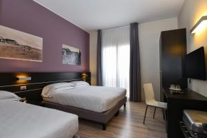 Posteľ alebo postele v izbe v ubytovaní Hotel Vienna