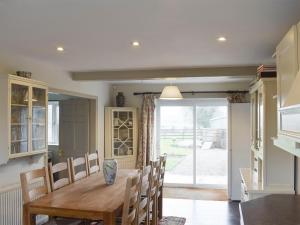 a kitchen and dining room with a wooden table and chairs at York House in Richmond