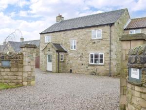 an exterior view of a stone house with a driveway at York House in Richmond