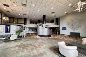 a lobby of a hospital with a staircase and chairs at Quality Inn & Suites Orland Park - Chicago in Orland Park