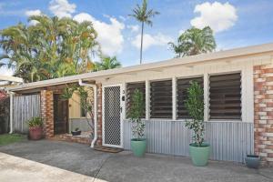 a house with two potted plants in front of it at 300m to beach*Pets allowed*Boho Beach Shack in Maroochydore