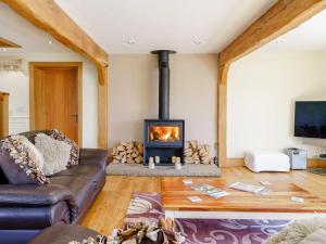 a living room with a couch and a fireplace at Admergill Lodge in Barrowford