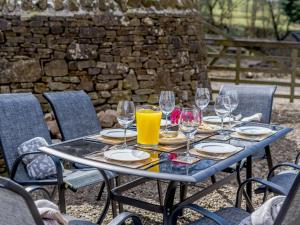 a table with wine glasses and food on it at Admergill Lodge in Barrowford