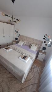a bedroom with a large white bed with two tables at GOLD in Mostar