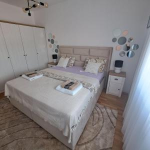 a bedroom with a large bed with purple sheets at GOLD in Mostar