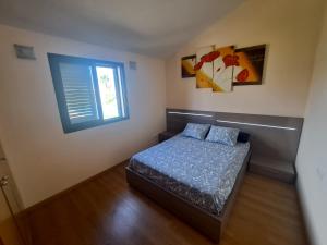 a small bedroom with a bed and a window at Villa Panorámica in Sant Jordi