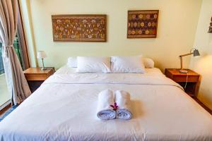 a bedroom with a bed with two towels on it at Villa Jado 3 - Lake and Mountain View Villa in Bedugul