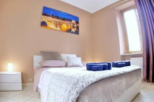 a bedroom with a bed and a large window at [Centro - vista Piazza Vittorio] / Wi-Fi & Netflix in Turin