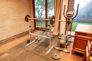 a room with a gym with two weights at Villa Jado 3 - Lake and Mountain View Villa in Bedugul