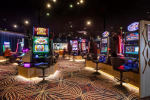a row of slot machines in a casino at Nightcap at Empire Hotel in Gepps Cross