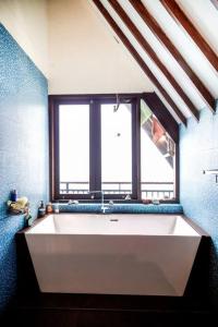 a large white tub in a bathroom with a window at Villa Jado 3 - Lake and Mountain View Villa in Bedugul +83 photos