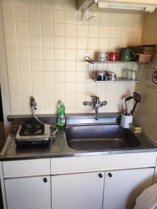 a kitchen counter with a sink and a stove at 10 minutes direct to Shibuya Crossing! Heart of Tokyo! Mishuku in Tokyo