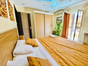 A bed or beds in a room at Panda Grey with balcony Hurghada center