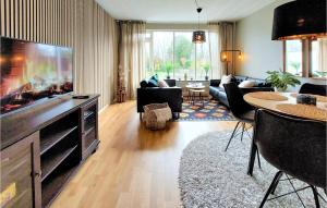 a living room with a large flat screen tv at Awesome Home In Viken With Wifi And 2 Bedrooms in Viken