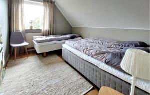 a bedroom with two twin beds and a window at Awesome Home In Viken With Wifi And 2 Bedrooms in Viken