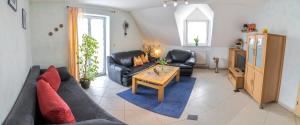 a living room with a couch and a table at Apartment / Ferienwohnungen Christ in Rothenburg ob der Tauber