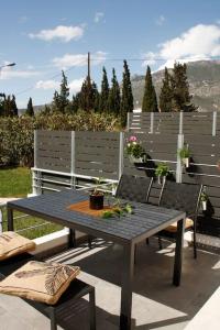 a table and chairs sitting on a patio at Cosy Cave Apartment by the sea in Loutraki