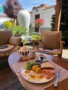a table with a plate of food on a table at Villa Sofia in Odesa