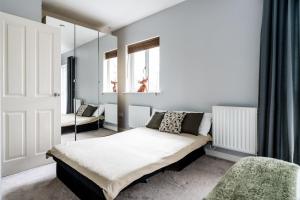 1 dormitorio con cama y espejo en Waterside Stay - City Centre with Parking, en Birmingham