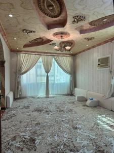 a large room with a ceiling with a fan at Alamjed Residence in Mecca
